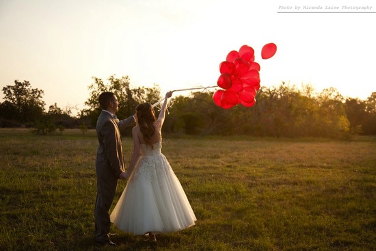 photo of bride groom outside after wedding ceremony release balloons