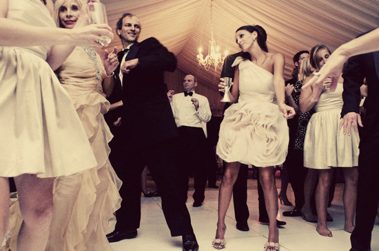 bride dances in little white dress at reception