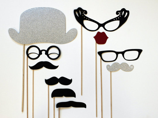 photo of Mad Men themed wedding photo booth props