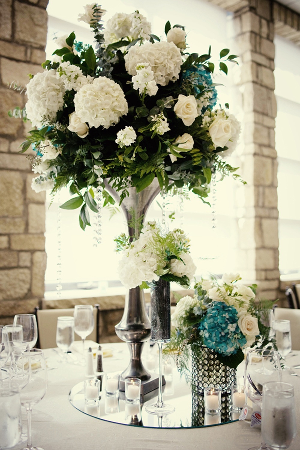Elegant-wedding-reception-centerpieces-ivory-hydrangeas-teal-accents.full