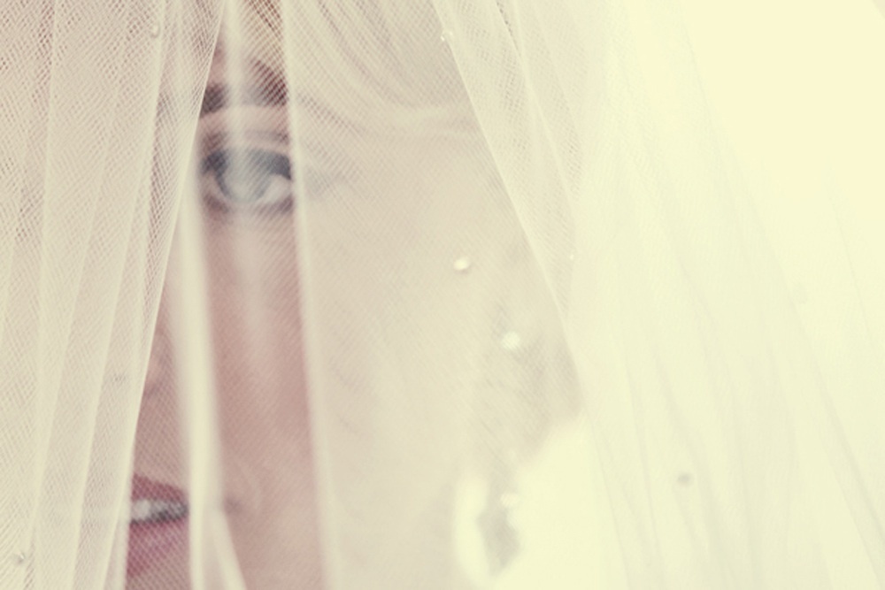 Artistic-wedding-photo-bride-wears-veil-before-ceremony.full