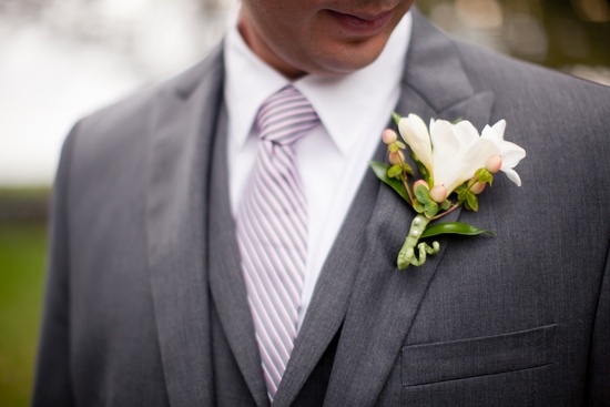 photo of handsome grooms attire charcoal gray suit white bout