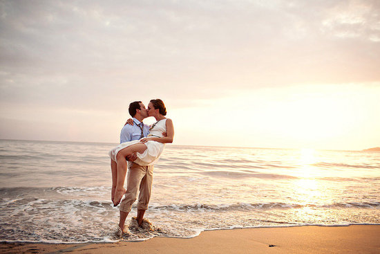 photo of destination wedding on beach bride groom kiss