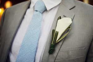 photo of Handsome grooms wearing tuxes and suits, elegant boutonnieres