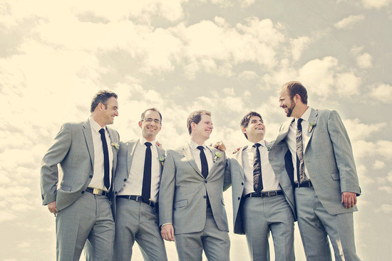 photo of Handsome grooms wearing tuxes and suits, elegant boutonnieres