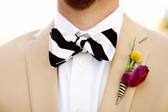 photo of Handsome grooms wearing tuxes and suits, elegant boutonnieres